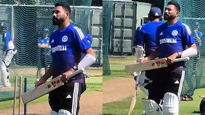 Mohammed Siraj reacts to his broken bat during practice